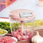 Pink manual garlic & onion chopper with chopped ingredients on a table